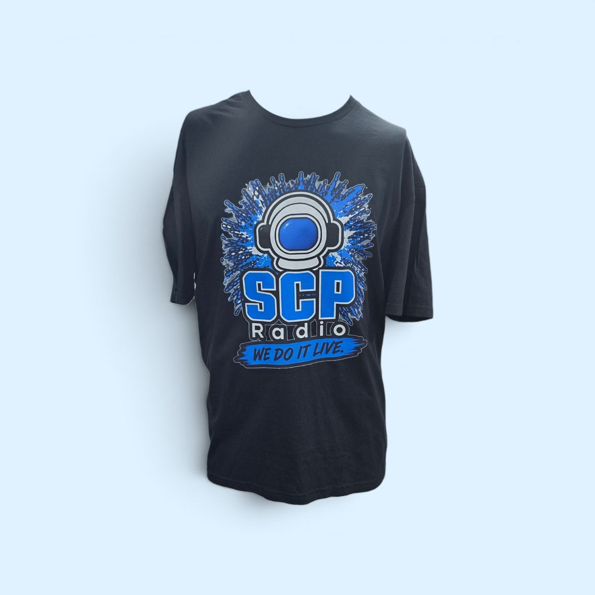 SCP Apparel black cotton crewneck t-shirt featuring a blue SCP Radio astronaut helmet graphic and We Do It Live text.