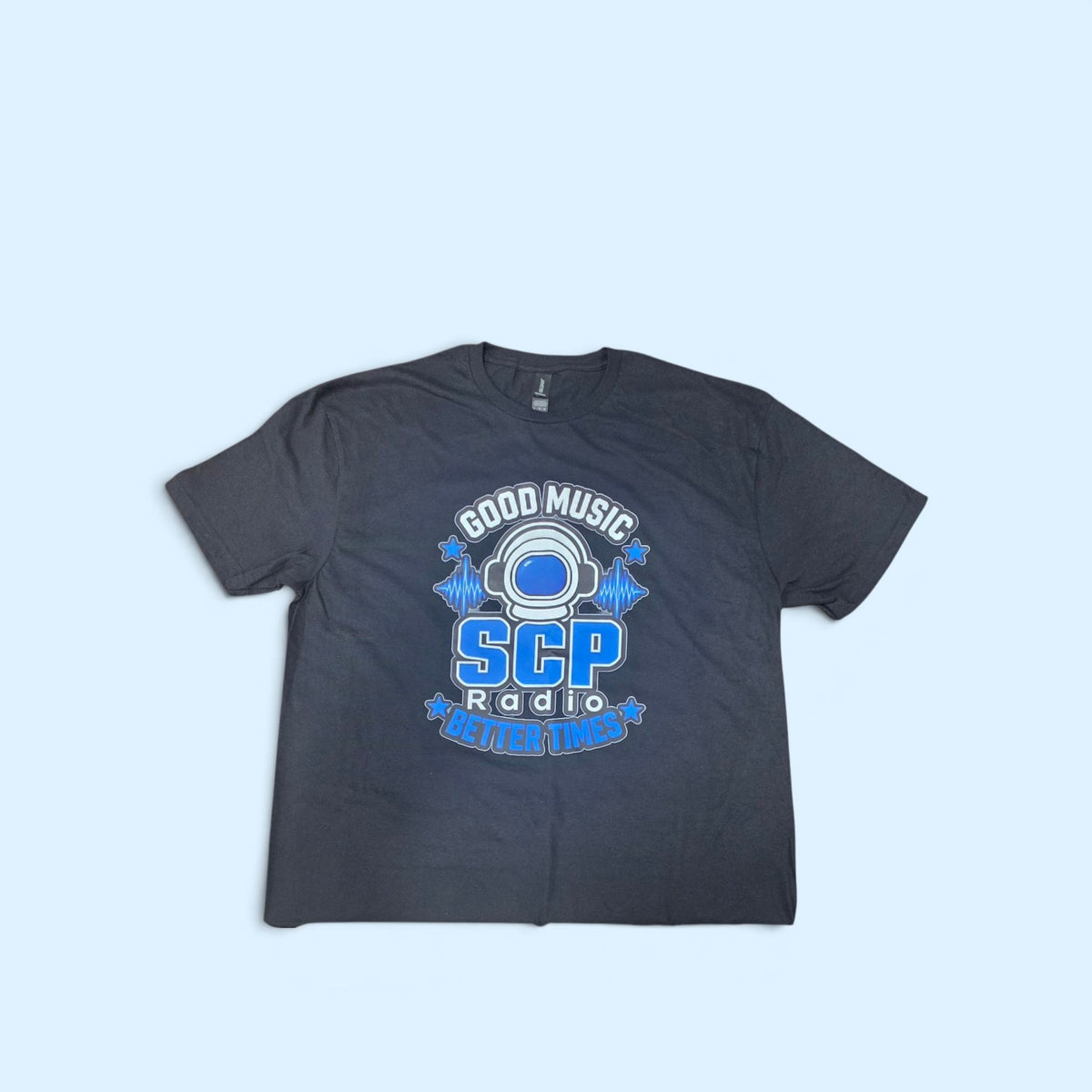 SCP Apparel black cotton crewneck t-shirt featuring an astronaut helmet graphic with blue sound waves and text.