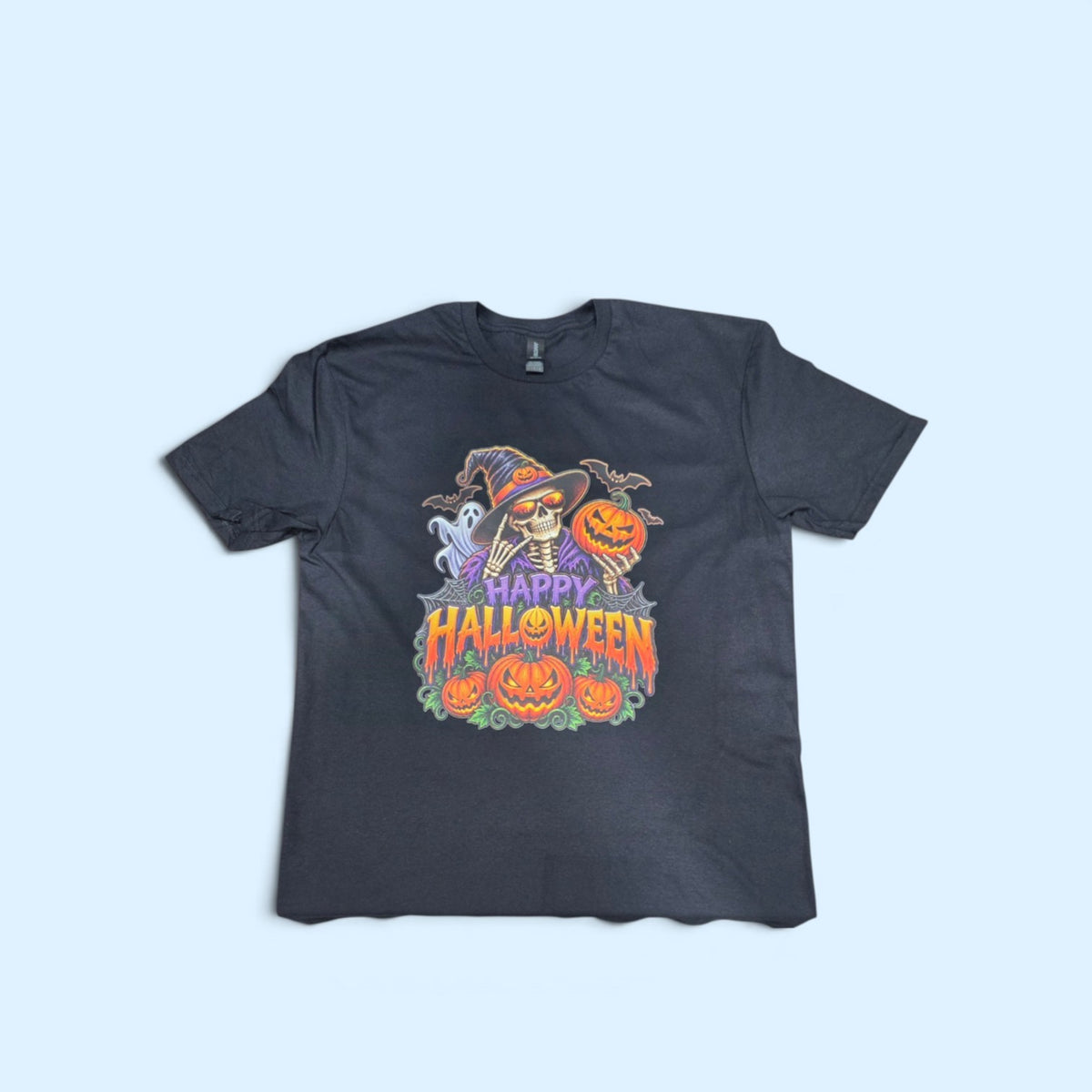 SCP Apparel black crewneck t-shirt featuring a colorful skeleton in a witch hat with pumpkins and bats graphic.