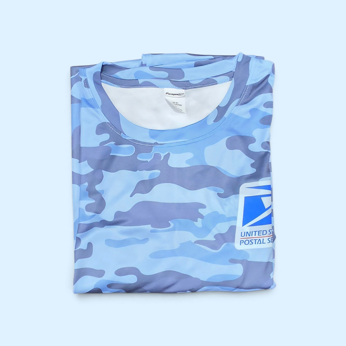 SCP Apparel blue camouflage long sleeve performance shirt with United States Postal Service logo on the chest