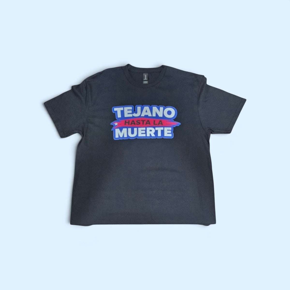SCP Apparel black crewneck t-shirt featuring Tejano Hasta La Muerte graphic print in blue, red, and white lettering.