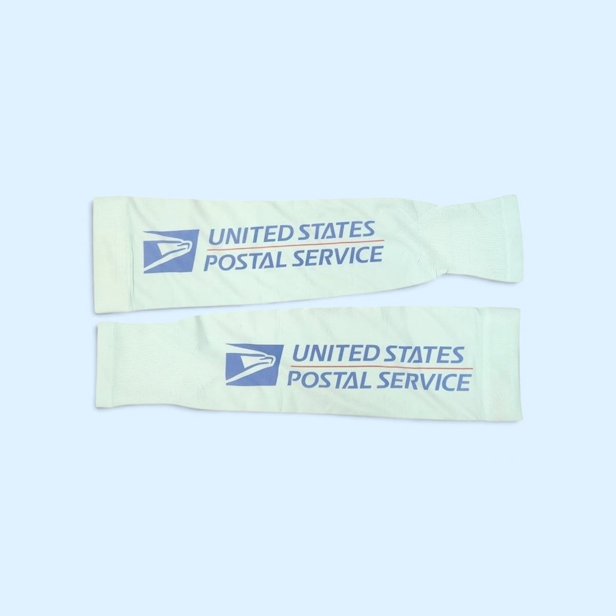 SCP Apparel white athletic arm compression sleeves with blue United States Postal Service logo and text