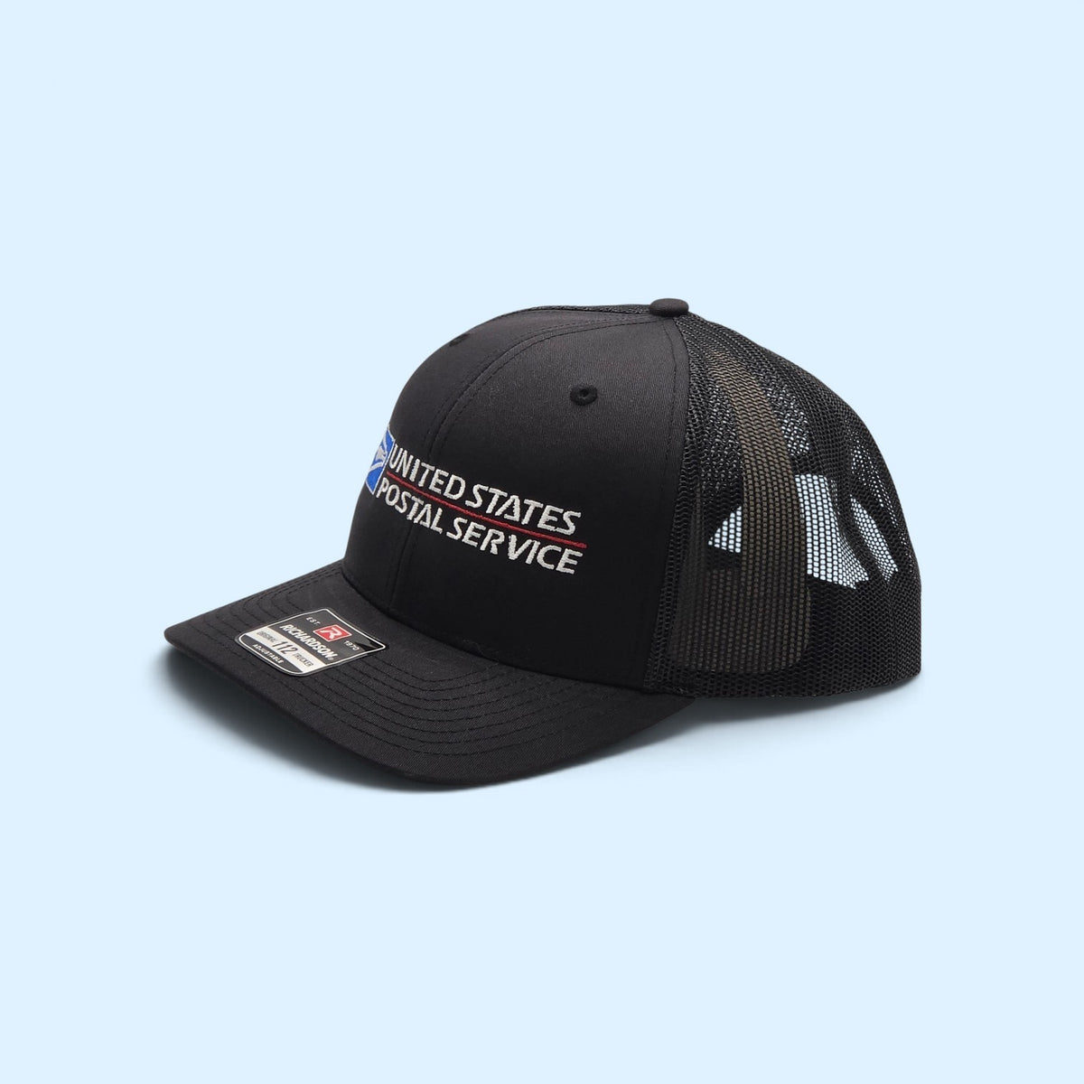 SCP Apparel black Richardson 112 trucker hat with embroidered United States Postal Service logo and mesh back