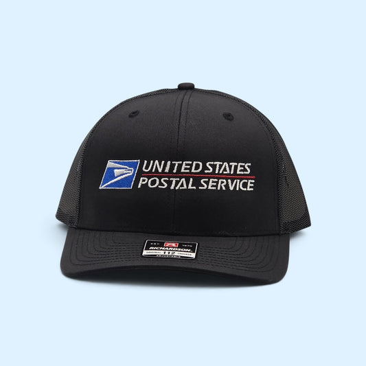SCP Apparel black Richardson 112 trucker hat with embroidered United States Postal Service logo and mesh back